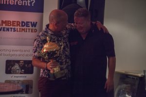 Lord Russell Baker presenting Colin Lloyd with the Norwich Charity Darts Masters Trophy 2017